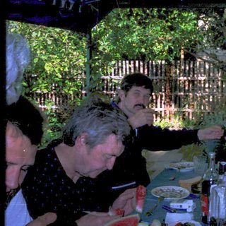 Group enjoying outdoor evening meal together.