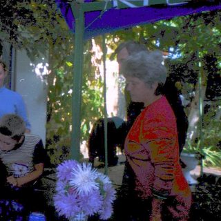 Family posing together outdoors under a canopy.
