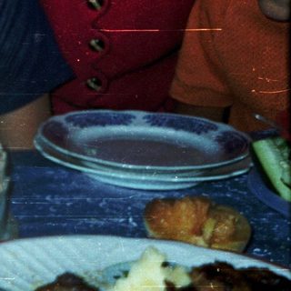 Boy blowing out birthday candles on cake.
