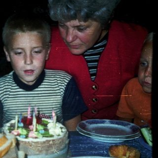 Boy blowing out birthday candles on cake.