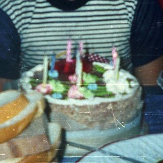 Boy blowing out birthday candles on cake.