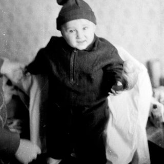 Young child wearing winter hat and coat.