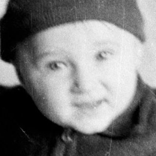 Young child wearing winter hat and coat.