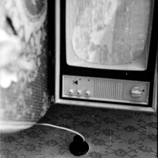 Vintage CRT television with analog dials.