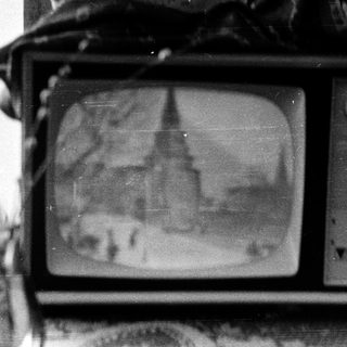 Old CRT television displaying unclear static image.