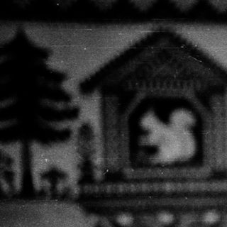 Baby peeking over crib railing indoors.