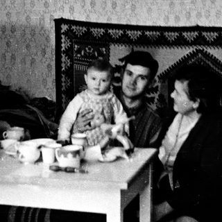 Family sitting indoors during meal time.