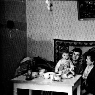 Family sitting indoors during meal time.
