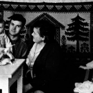 Family sitting indoors during meal time.