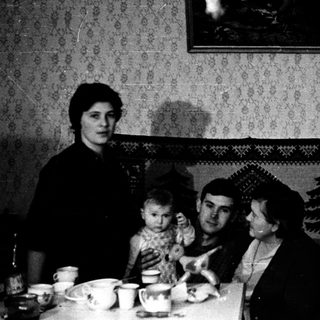 Family gathering indoors during meal time.
