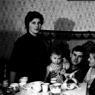 Family gathering indoors during meal time.