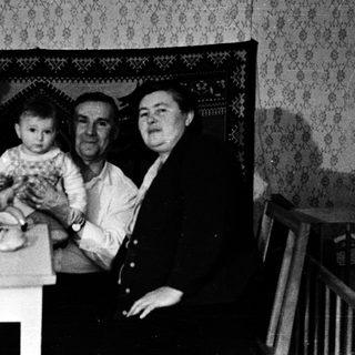 Family gathering around a table indoors.
