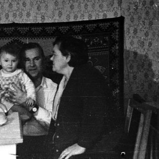 Family gathering indoors during evening meal.