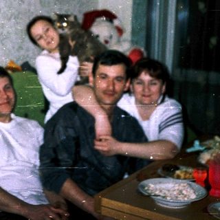 Family posing indoors during a gathering.