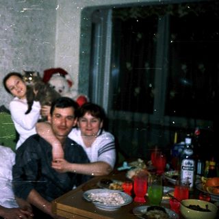Family posing indoors during a gathering.