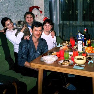 Family gathering indoors during holiday celebration.