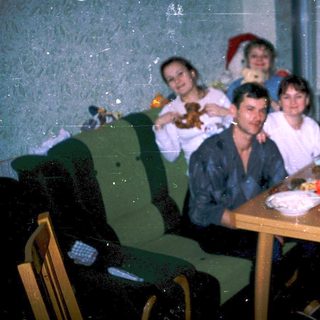 Family gathering around festive dinner table indoors.