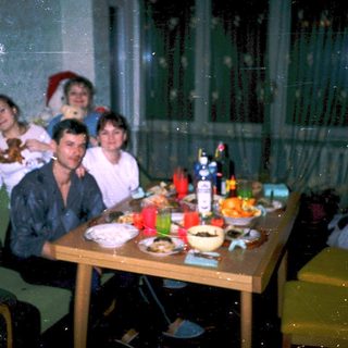 Family gathering around festive dinner table indoors.