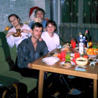 Family gathering around festive dinner table indoors.