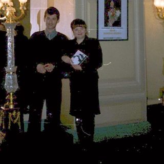 Three men in formal attire posing indoors.