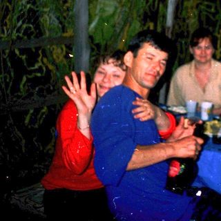 Group enjoying meal together outdoors at night.