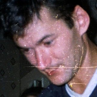 Man pouring beer from keg into glass.