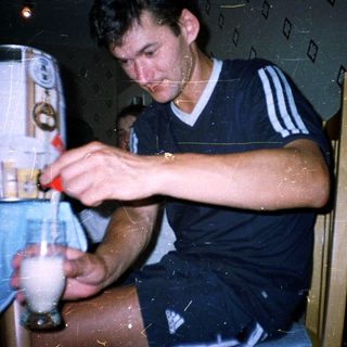Man pouring beer from keg into glass.