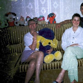Four people sitting indoors during a bubble party.