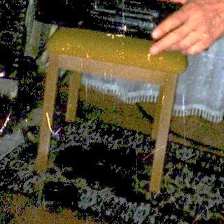 Man playing piano during indoor rain simulation event.