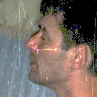 Man playing piano during indoor rain simulation event.