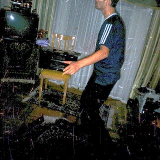 Man playing piano during indoor rain simulation event.
