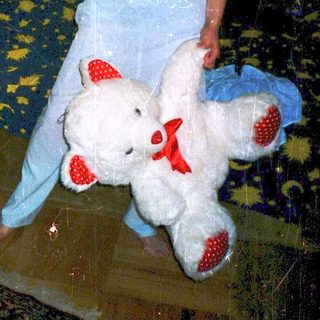 Woman holding stuffed animals in living room.