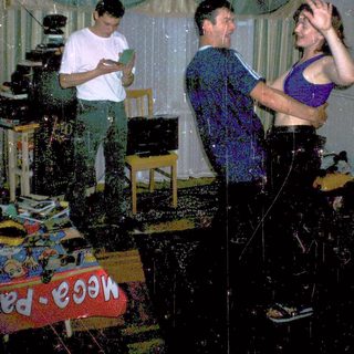Water fight party indoors with three people.