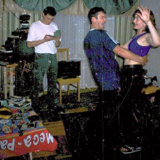 Water fight party indoors with three people.