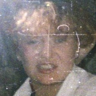People in an elevator with one person pointing.