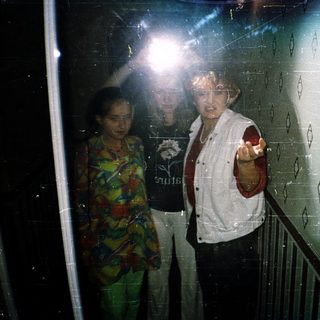 People in an elevator with one person pointing.
