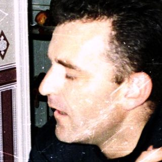 Two people having a meal indoors, pointing and laughing.