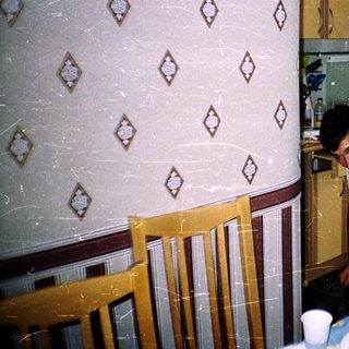 Two people cleaning a kitchen with water.