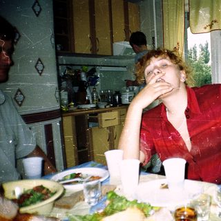 Person resting hand on face at home meal.