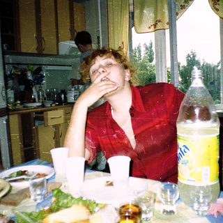 Person resting hand on face at home meal.