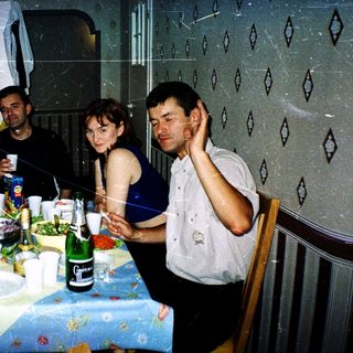 Group celebrating indoors with food, drinks, and confetti.