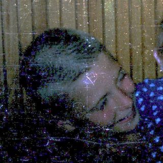 Two people, likely mother and child, playing in water through a window.