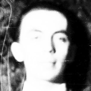 Blurred black-and-white portrait of a man in suit.