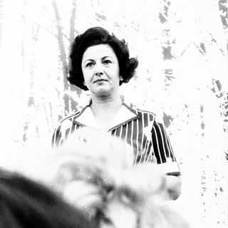 Woman speaking at an indoor event.