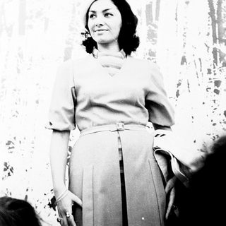 Elegant woman in formal attire posing indoors.
