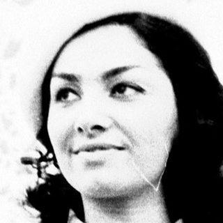Elegant woman in formal attire posing indoors.