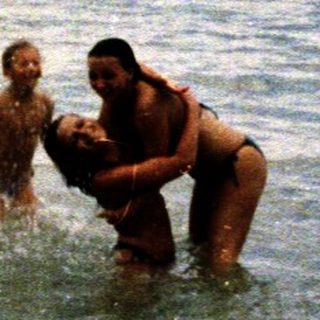 People enjoying swimming and playing in ocean water.