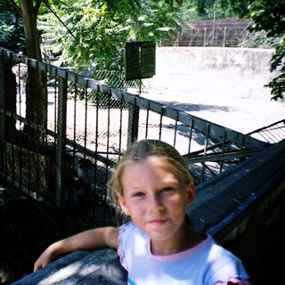 Girl sitting on a roller coaster ride.