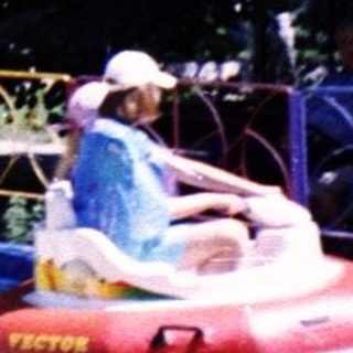 Water bumper boats with riders on a pool.