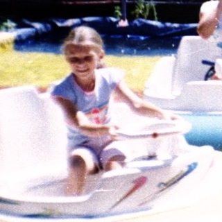 Children riding bumper boats in a water park.